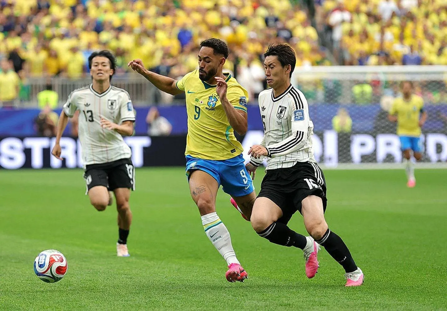 HOUSTON, TEXAS - JUNE 29: Matheus Cunha #9 of Brazil is challenged by Daichi Kamada #15 of Japan during the FIFA World Cup 2026 Round Of 32 match between Brazil and Japan at Houston Stadium on June 29, 2026 in Houston, Texas.