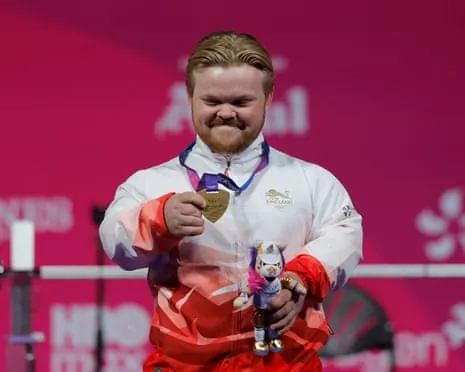 Mark Swan of England celebrates after winning the first gold medal of the Games in the men's lightweight para-powerlifting.