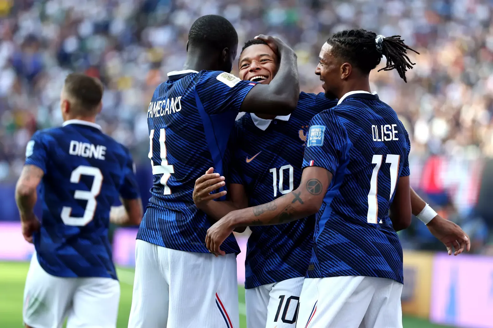 Kylian Mbappe celebrates with French teammates Dayot Upamecano and Michael Olise during their World Cup win over Sweden.