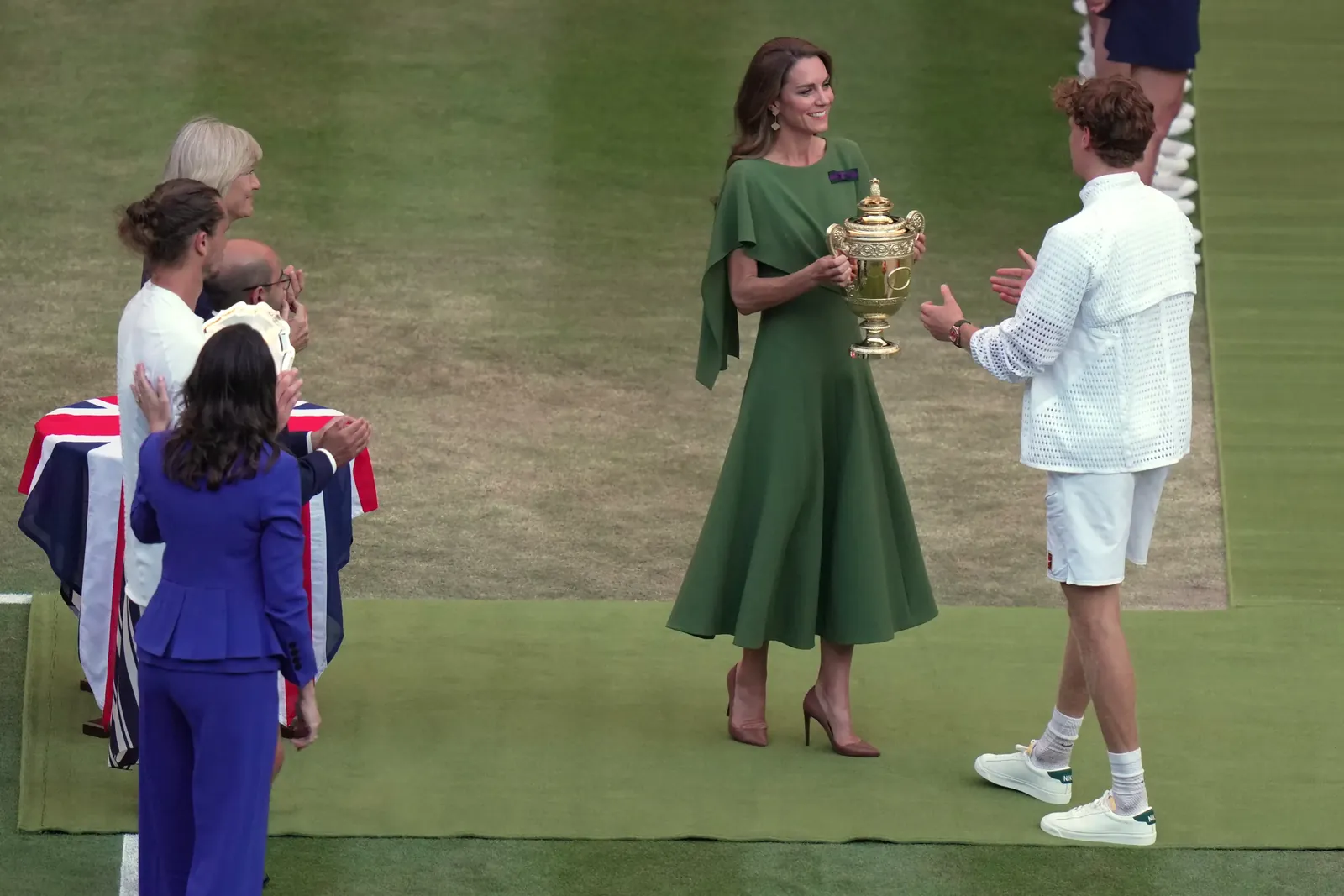 Britain's Princess Kate presents the champion trophy to Jannik Sinner of Italy after winning against Alexander Zverev of Germany in the men's singles final at Wimbledon Tennis Championships in London, Sunday, July 12, 2026. (AP Photo/Brian Inganga)