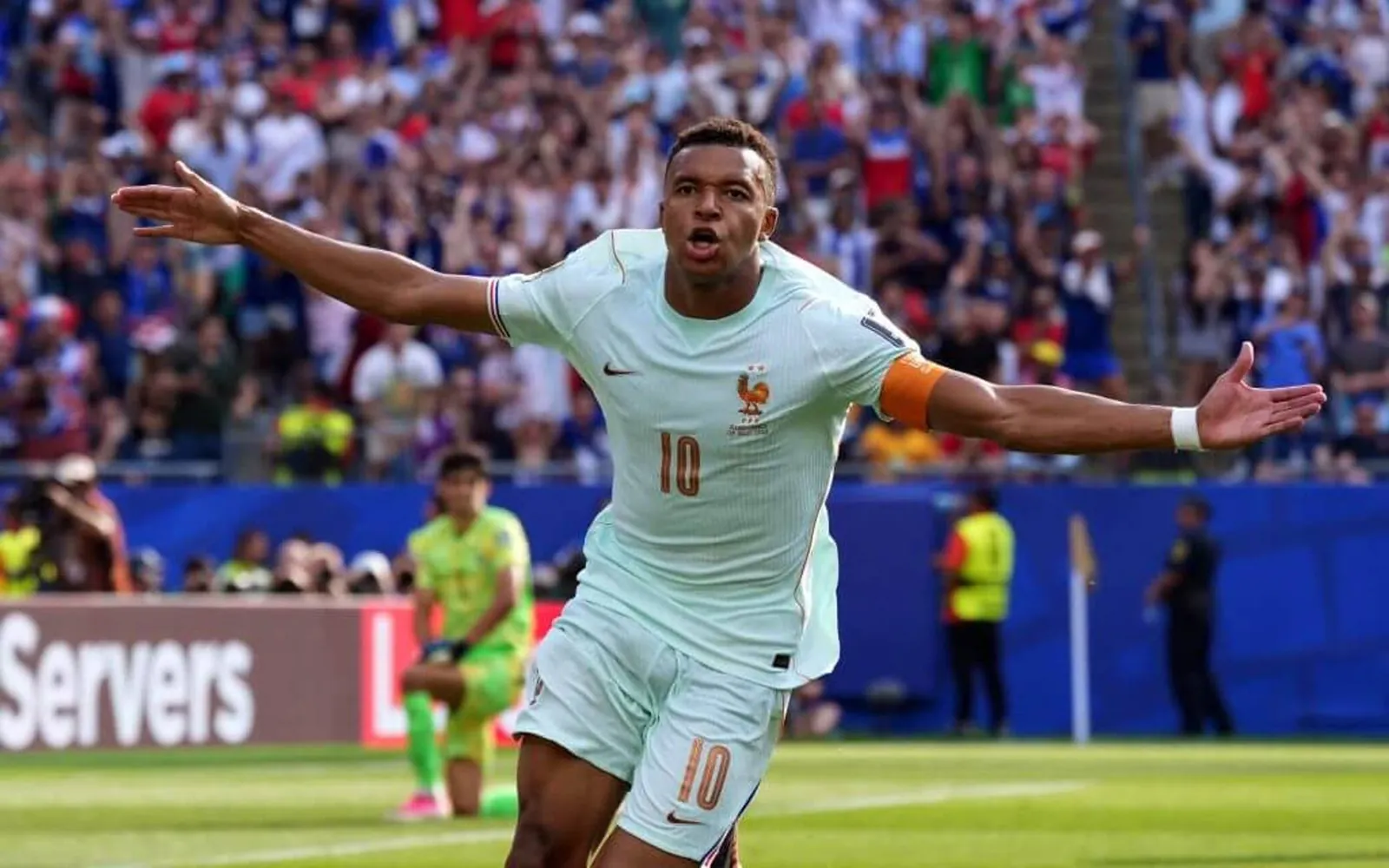 Mbappe, arms outstretched, celebrates scoring the first goal for France against Morocco