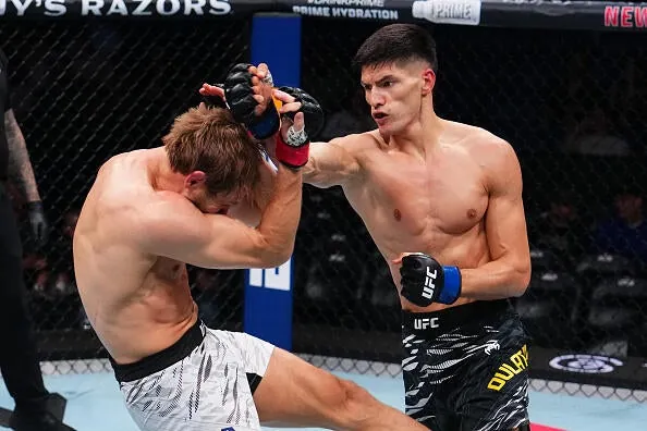 Islam Dulatov of Russia punches Adam Fugitt in a welterweight bout during the UFC 318 event at Smoothie King Center on July 19, 2025 in New Orleans, Louisiana. (Photo by Cooper Neill/Zuffa LLC)
